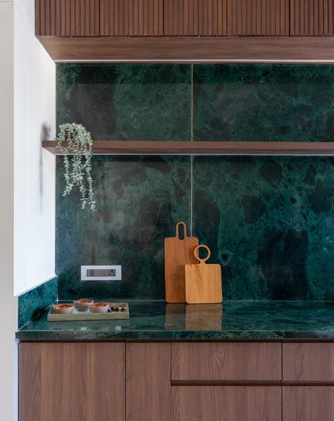 | Emerald retreat | Dining area | Adding a vibrant touch to the heart of the home! 💚 With green granite countertop, our kitchen design stands out in a sea of neutrals. The warmth of wooden cabinets complements the elegance of natural stone, making this space truly inviting. #codesigns #emeraldretreat #kitchendesign #woodenfurniture #greengranite [Green Granite, Kitchen Design, Wooden Cabinets, Interior Inspiration, Neutral Palette] Photography by : @archi.capture_ Green Marble Kitchen Countertops, Sea Green Interior, Kitchen Design Wooden, Green Kitchen Countertops, Green Granite Kitchen, Marble Benchtop, Sage Kitchen, Kitchen Colours, Marble Countertops Kitchen