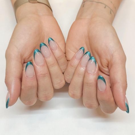 French mani, but make it ✨festive✨ with a pop of holiday color! @glossy.studios used #PutItInNeutral and #TealingFestive. 💅 #FrenchManicure #HolidayNails #NailInspo #NailTech #FrenchMani #FrenchTips Blue Shimmer French Tip Nails, Metallic Blue French Tips, Teal Chrome French Tip Nails, Torquise Nails French Tip, Blue And Green French Tip Nails, Teal Cat Eye Nails, Teal French Nails, Turquoise French Tip, Turquoise French Tip Nails