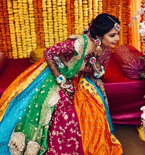 Photo via Aynaa | bride wearing beautiful multicoloured lehenga for her mehendi day | lehenga with multicoloured plates and embroidery work | marigold background decor | that bridal mehendi though | #mehendi #outfit #mehendioutfit #mehendidesigns #outfits #outfitoftheday #outfitideas #outfitinspiration #lehenga #lehengablousedesigns #embroidery #floraljewellery #indianbride #indianbridesinstagaram #indianbrideslike #henna #hennamehndi Mehndi Ceremony Outfit For Bride, Dress Colour Combination Ideas, Mehendi Looks For Bride, Dress Colour Combination, Day Lehenga, Multicoloured Lehenga, Marigold Background, Lehenga For Mehendi, Mehendi Lehenga