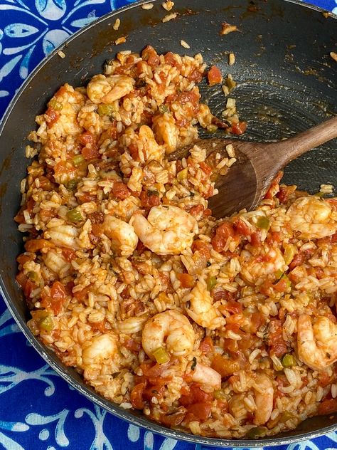 Wooden spoon stirring jambalaya with shrimp in a large skillet on a colorful blue napkin Shrimp Jambalaya Recipe, Shrimp And Scallop Recipes, Shrimp Jambalaya, Cajun Jambalaya, Salmon Patties Recipe, Shrimp Scallops, Easy Skillet Meals, Jambalaya Recipe, Easy Skillet