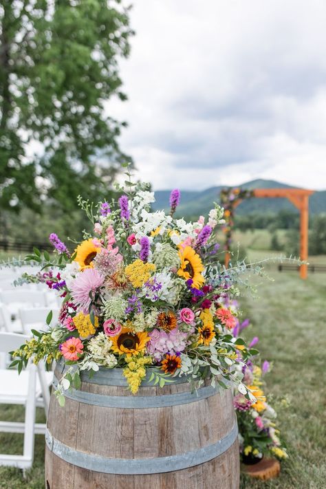 Floral Arrangement on Wine Barrel for Ceremony Wedding Aisle Wedding Tablescapes Wildflowers, Wedding Wildflower Centerpieces, Outdoor Wedding Flower Ideas, Summer Rustic Centerpieces, Wildflower And Eucalyptus Wedding, Wildflower Rustic Wedding Theme, Wild Flowers Wedding Centerpiece, Field Flowers Wedding, Wildflower Wedding Flower Arrangements