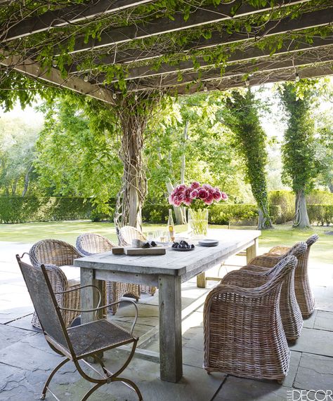 On the terrace, a pergola covered in white wisteria shades an outdoor dining area with a reclaimed teak table, a French iron chair, and rattan chairs with Sunbrella cushions, all from Bloom; the paving tile is natural cleft bluestone. Provincial Decor, Summer House Design, Design Per Patio, French Provincial Decor, Small Patio Furniture, Small Patio Decor, Covered Pergola, Raised Bed, Small Patio