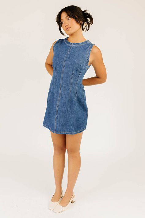 vintage-inspired + full of versatility, this high-neck denim mini dress will take you from summer concerts to fall coffee dates. with its medium wash + subtle a-line silhouette, you can easily dress it up + down, day or night. we love it paired with anything from chunky knee high boots to dainty ballet flats dark denim // mini length, high neckline, back zipper closure, seam detailing, darts model is 5'8" + wearing a small measurements are approximate + taken while laying flat small : bust 32” l Denim Fall Dress, Chunky Knee High Boots, Dressy Summer Outfits, Outfit Ideas Dressy, Short Sleeve Denim Dress, Summer Concerts, Date Night Outfit Summer, Coffee Dates, Summer Capsule Wardrobe