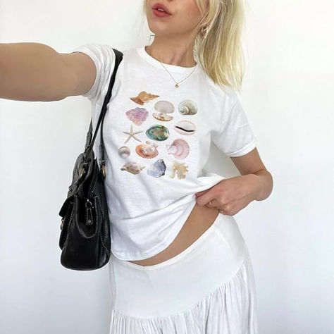 🐚The cute summer shirt you’ve always wanted! This very aesthetic seashell design top is perfect for your summer wardrobe ☀️⛱
🐚Material: Polyester blend y2k graphic baby tees for women fruit bow shirt crop top vintage aesthetic teen girl clothes 90s summer clothing, comfy, soft, lightweight and breathable, very skin-friendly fabric, comfortable to wear
🐚Style: Cute y2k graphic baby tees for women, white baby tee, vintage grunge clothes, baby crop tees, y2k graphic tee crop top, simple & classy Baby Graphic Tees, Bow Shirts, Vintage Crop Tops, Baby Tees, Self Design, Summer Tee, Tees For Women, Dresses With Leggings, Vintage Tops