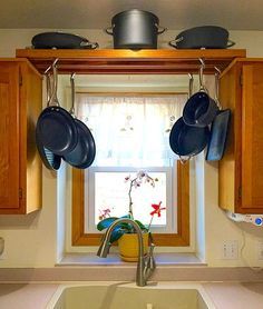 Forget trying to stack pots and pans in the cabinet. Build this easy DIY pot rack to increase storage space and better organize your kitchen. Pot Rack Above Sink, Diy Pot Rack, Kitchen Rack Design, Pan Storage Diy, Diy Kitchen Cabinets Build, Over The Kitchen Sink, Stacked Pots, Cabinet Build, Kitchen Window Sill