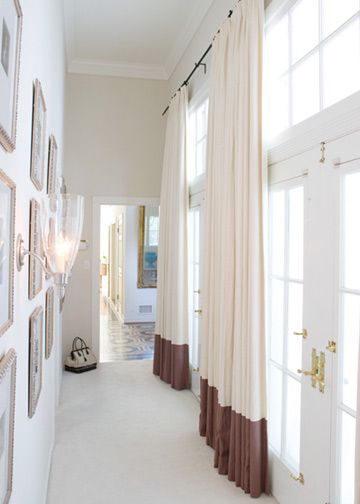 Elegant foyer with a wall of French doors and transom windows dressed with floor length ivory drapes banded with a mauve border, two-tone curtains. Two Tone Curtains, Color Block Curtains, Hotel Ideas, House Deco, Striped Curtains, Short Curtains, Drapery Panels, Window Styles, Curtain Designs