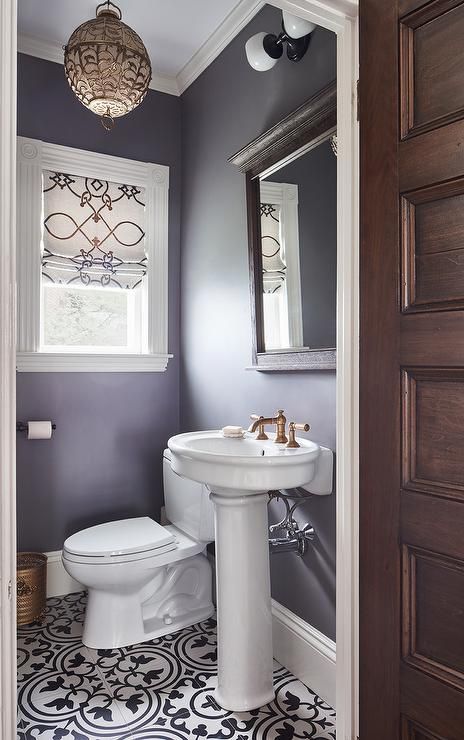 A black and white scroll roman shades hangs from a window in this purple Moroccan themed powder room lit by a gold lantern. Lavender Bathroom, Small Bathroom Window, Purple Bathroom Decor, Purple Bathroom, White Bathroom Decor, Purple Bedrooms, Purple Bathrooms, House Bathrooms, Pic Art