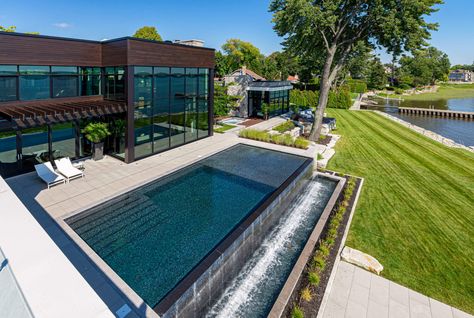 A dream pool built for our clients with all the trimmings: infinity edge, sun ledge, beach, PebbleTec finish, spa, waterfall and custom concrete construction. Une piscine de rêve construite pour nos clients avec toutes les options: déversement, plage, finition PebbleTec, spa, fontaine et une construction en béton sur mesure. Infinity Pool Backyard, Pool Infinity, Spa Waterfall, Desert Landscape Design, Swimming Pool Waterfall, Contemporary Pool, Edge Pool, Swimming Pool Architecture, Concrete Construction