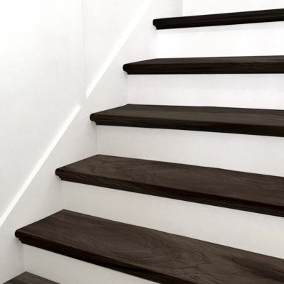 With modern, steely-grey hues and light knots and graining, Stair Tread Luxury Vinyl Tile adds style and elegance to a space. With MSI's Stair Tread, installation is easy, saving you time. There is no need to join a nose to a flooring plank, no join lines or gaps, and the finished look is professional and high-end. Use this gorgeous wood-look stair tread in the kitchen, living room, bathroom, or basement to create a seamless transition from floor to stairs. | MSI Luxury Vinyl Stair Tread Eased E Dark Wood Stairs With Runner, Vinyl Plank Stairs, Black Painted Stairs, Vinyl Stair Treads, Stairs Colours, Basement Finish, Stair Tread Covers, Stair Renovation, Vinyl Stairs