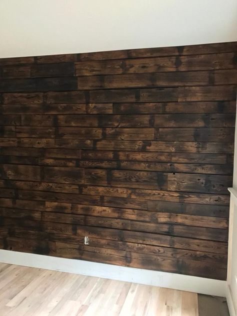 Also known as shou sugi ban, we charred oak for this accent wall. Pallet Wall Decor Living Room, Shou Sugi Ban Accent Wall, Burnt Wood Accent Wall, Burnt Wood Trim, Rough Cut Lumber Walls, Basement Accent Wall Ideas, Stained Wood Walls, Charred Wood Wall, Shou Sugi Ban Wall