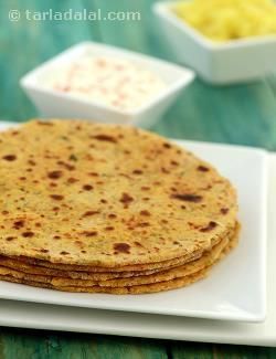 Many elders believe that if you want to have a quick and healthy meal, there’s nothing like khichdi! They are very right. Khichdi is so healthy even the leftover should not be wasted. So, here is a way of making parathas using khichdi combined with whole wheat flour and besan. The Masala Khichdi Paratha is a great breakfast option, but can be carried to work as well if you wish. They are filling and nourishing, and tasty too thanks to an assortment of flavourful additions to the dough. With ... Roti Recipe Indian, Masala Khichdi, Indian Flat Bread, Cholesterol Foods, Paratha Recipe, Roti Recipe, Recipe Indian, Paratha Recipes, Indian Bread