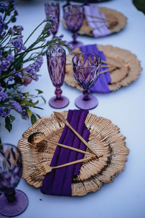 I placed three shades of purple and complimented with Purple shaded Glassware and blended up with Gold. Purple And Rose Gold Party, Royal Blue Purple And Gold Wedding, Purple And Gold Wedding Theme Decor, Purple Gold Birthday Party Decoration, Royal Purple And Gold Wedding Theme, Dark Purple And Gold Wedding, Gold Chargers Place Setting, Gold And Purple Aesthetic, Purple And Gold Party Decorations