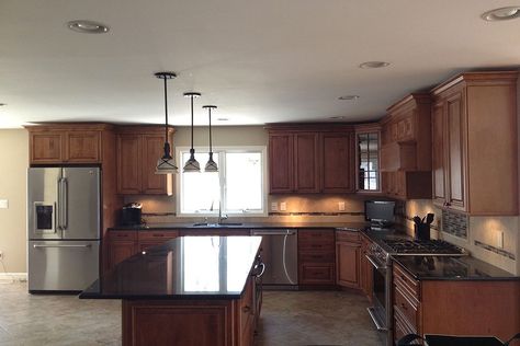 Black Pearl granite kitchen countertops dark cabinets. This attractive kitchen featured with a porcelain tile floor. The key is, try to keep the contrast with a reasonable level. When you combined Black Pearl with cherry cabinets backsplash soft contrast should be caught. #blackpearlgranite #blackpearlgranitekitchencountertop #blackpearl #blackpearlgranitecountertop #blackpearlcounters #blackpearlkitchengranitecounters Cherry Kitchen Cabinets Black Countertop, Cherry Cabinets Dark Countertops, Black Brown Granite Countertops Kitchen, Cherry Cabinets Black Countertops, Kitchen Countertops Dark, Countertops Dark Cabinets, Black Leathered Granite Countertops, Kitchen Countertops With White Cabinets, Backsplash Black Granite