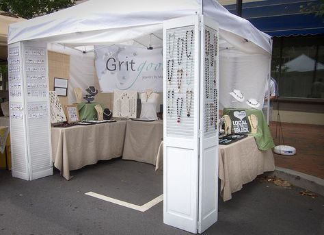 Hide poles and display with large window screens & vintage shutters #visualmerchandising #storedisplay Creative Booths, Vendor Booth Display, Craft Fair Booth Display, Jewelry Booth, Craft Show Booths, Craft Show Booth, Craft Booth Display, Vendor Displays, Jewerly Displays