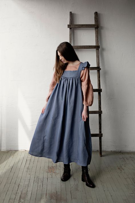 Prairie dress is made from 100% soft and washed linen. Details: - Colour: Dusty blue - Composition: 100% Oeko-Tex certified linen - Flutter sleeves - Coconut buttons down the back - Medium weight linen - Linen care: machine wash gentle; tumble dry low, ironing optional - The price is for one dress, other pictured items are not included Prairie Fashion, Dress With Wings, Linen Pinafore Dress, Dress With Flutter Sleeves, Blue Apron, Dress Linen, Womens Aprons, Apron Dress, Prairie Dress