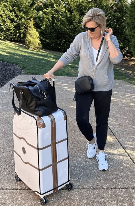 Over 50 Fashion blogger, Tania Stephens, is wearing a travel outfit with Delsey luggage Leggings Travel Outfit, Delsey Chatelet, Travel Outfits Women, Delsey Luggage, Cute Travel Outfits, Skort Outfit, Fall Travel Outfit, 50th Clothes, Fashion Travel Outfit