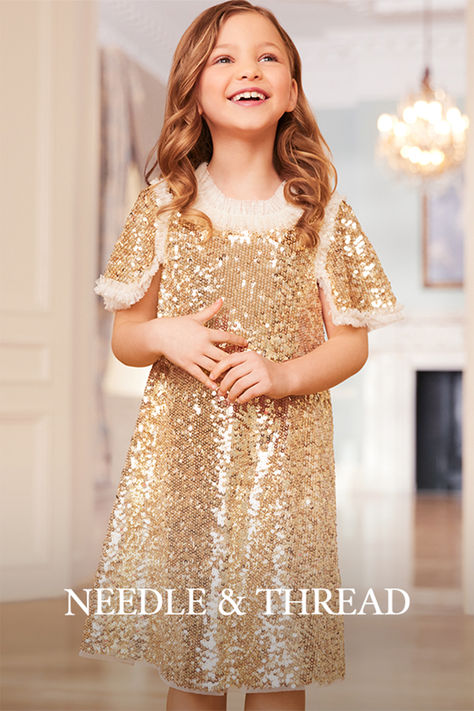 The Matilda Dress in Gold. This beautiful dress is decorated with shimmering sequins, creating an ultimate sparkle. Designed with square cut sleeves trimmed with tulle ruffles to add a Needle & Thread signature look. Update your little one's wardrobe with the ultimate fairy-tale dress of the season. Sequin Flower Girl Dress, Tale Dress, Tulle Ruffles, Children's Dresses, Sequin Flower, Girls Lace Dress, Dresses For Girls, Sequin Party Dress, Fairytale Dress