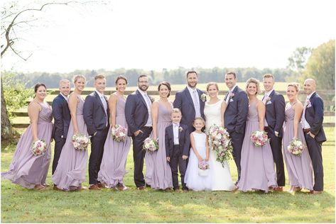 Full bridal party. Bridesmaids wearing long purple dresses, groomsmen wearing blue suits Purple Bridesmaids Blue Groomsmen, Purple Bridesmaid Dresses With Groomsmen, Bridal Party Purple, Lilac Groomsmen, Long Purple Dresses, Groomsmen Attire Purple, Lavender Bridal Party, Dianas Wedding, Wedding Tuxes