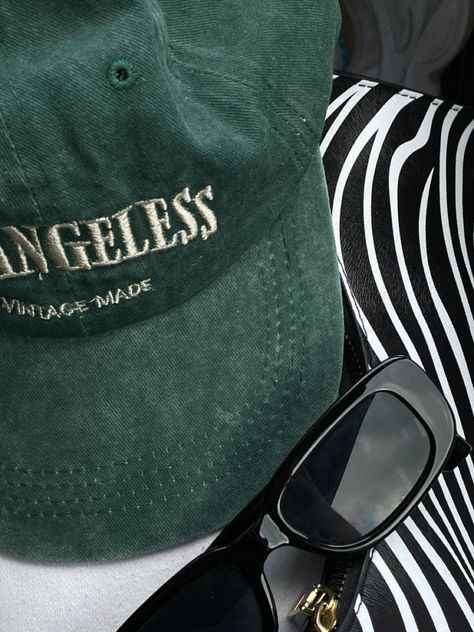 green vintage cap, a pair of black sunglasses and a zebra bag. picture taken in a car. #aestheticlypleasing #aesthetic #fashion #trendy #trendystreetstyle #fillerpic filler pic #vintagestyle #vintageaesthetic #ootd #ootdfashion Cap Pictures Aesthetic, Green Cap Aesthetic, Green Hat Aesthetic, Zebra Bag, Bag Picture, Filler Photos, Hat Aesthetic, Dark Green Aesthetic, Drop Shot