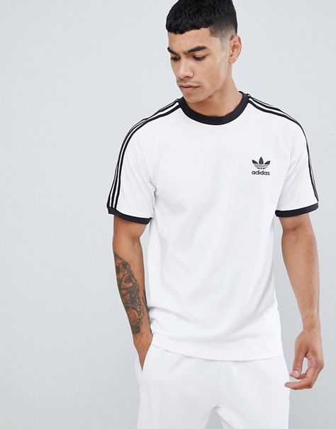 adidas Originals adicolor california t-shirt in white cw1203 | ASOS Adidas Tshirt Outfit, Addidas Shirts, Adidas Outfit Men, Looks Adidas, Adidas Sweat, Adidas Originals Logo, 70s T Shirts, Sweat Suits, Adidas Tshirt