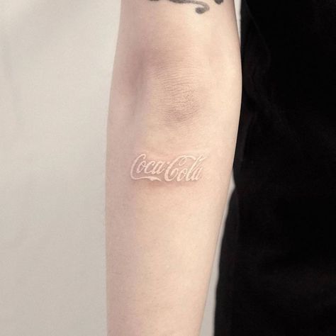 White ink Coca Cola logo tattoo. Coca Cola Tattoo, United States Culture, Coca Cola Logo, Contemporary Pop Art, Little Tattoos, White Ink, Tattoo Artist, Coca Cola, Tattoo Artists