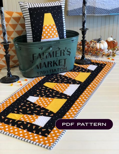 This listing is for one PDF pattern only. This is not a finished product. This is a digital download. Download will be sent to the email address linked to your Etsy account. PDF cannot be downloaded in the app, but can be found in your email through your browser. Full color pattern includes instructions for a 15" x 35" candy corn table runner and a coordinating pillow!!  Fabrics are not specifically sourced. Use fabrics of your choice to create a traditional or pink colorway. So many possibiliti Candy Corn Quilted Table Runner, Candy Corn Table Runner, Halloween Quilted Table Runner, Quilted Halloween Table Runners, Fall Table Runners Patterns Free, Simply Eilene, Corn Table, Halloween Runner, Table Runner Halloween