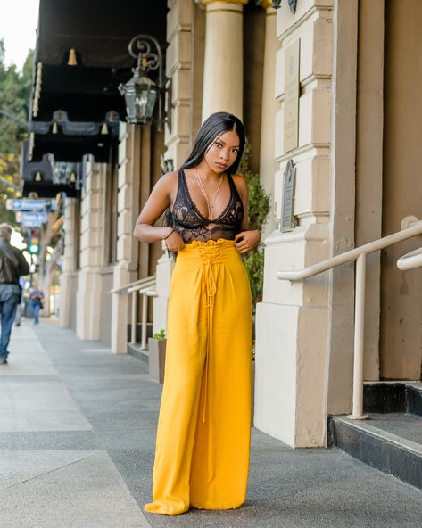 Full outfit from fashion nova, black bodysuit and long yellow palazzo pants. @sexiemaggie on instagram. Yellow Satin Pants Outfit, Mustard Palazzo Pants Outfit, Yellow Palazzo Pants Outfits, Yellow Bodysuit Outfit, Pallazo Outfit, Bell Pants Outfit, Lace Pants Outfit, Teen Fashion Outfits Summer, Satin Pants Outfit