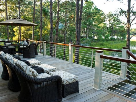 This back deck overlooking the marsh includes a dining table and umbrella and a wicker seating area with ottomans. Hgtv Dream Homes, Deck Pictures, Hgtv Dream Home, Kiawah Island, Backyard Deck, Outdoor Sconces, Deck Railings, Outdoor Deck, Railing