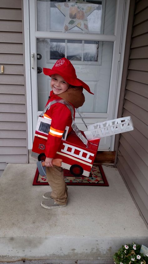 Homemade Halloween costume. Fireman costume. Firetruck made out of a diaper box. Firetruck Costume, Firetruck Halloween Costume, Firetruck Family Costume, Diy Fire Fighter Costume Kids, Homemade Firetruck Costume, Firetruck Diy Costume, Fire Truck Stroller Costume, Fireman Costume, Firefighter Costume