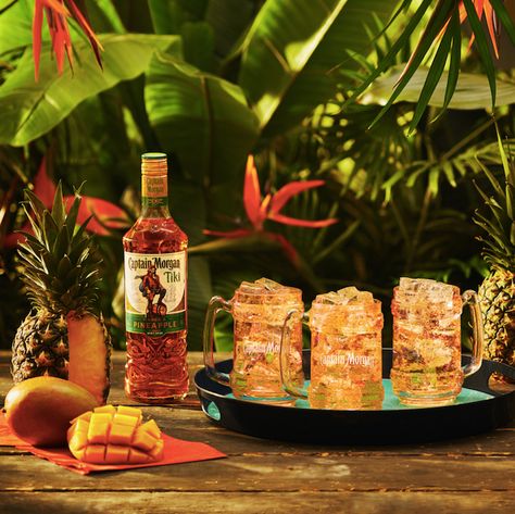 Captain Morgan's Tiki spiced rum Caramel Banana Cake, Mango And Pineapple, Captain Morgan Rum, Mango Cocktail, Mango Rum, Rum Tasting, Summer In A Bottle, Flavoured Gin, Ripe Pineapple