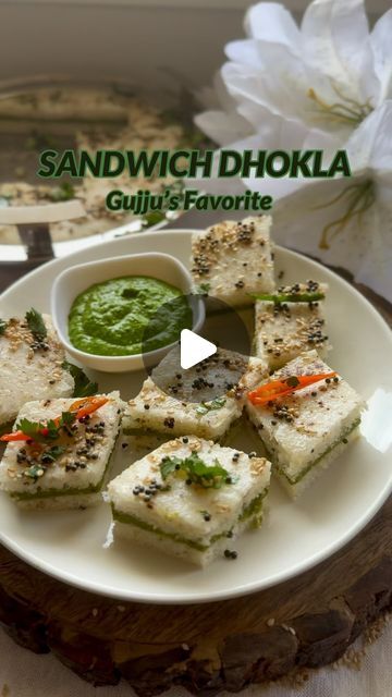 TheKitchenetteStudio on Instagram: "Sandwich Dhokla🤤💚🌿🥪 Gujarati Farsan Recipe 🤤🤤  Sandwich Dhokla is essentially a variation of the traditional dhokla, a savory steamed cake originating from the Indian state of Gujarat. What sets Sandwich Dhokla apart is its layered construction, resembling a sandwich, hence the name.♥️  This dish is not only visually appealing but also bursting with flavor, combining the tanginess of the chutneys with the soft, spongy texture of the dhokla. It’s a beloved snack in Gujarati cuisine, enjoyed as a breakfast item, tea-time treat, or appetizer at parties and gatherings.🎉🌿💚  Ingredients  For green chutney  Coriander leaves with stems  3 green chili  1 inch ginger Salt to taste  1/4 cup peanuts  1 tsp sugar 1/4 tsp cumin powder  1/4 Cup black salt  For Gujarati Farsan Recipe, Gujarati Food Recipes, Tea Time Snacks Indian, Sandwich Dhokla Recipe, Idli Batter, Gujarati Cuisine, Gujarati Snacks, Dhokla Recipe, Steamed Cake