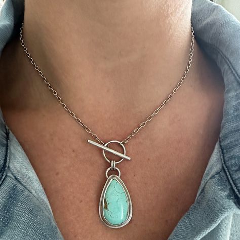 An every day staple necklace with the ease of a front toggle closure. Beautiful teardrop Royston Turquoise set in .925 fine silver and finished on 16" sterling silver chain. Pendant measures 30 x 16.5mm All of my work is hand crafted, from sourcing the stones from sustainable miners and lapidary artist, to forging the piece from sterling and fine silver sheet metal and wire. Over time, sterling silver develops a lovely patina, the more you wear this piece, the more it maintains its original shine. But if it starts to darken, a gentle polish with a soft jewelry cloth will bring it back to life. If you have any questions about this ring or any other pieces, feel free to reach out. Although I'm unable to accept returns or exchanges at this time, I'm here to assist you in finding the perfect t Toggle Necklace Silver, Leather And Sterling Silver Necklace, Get Back Necklaces Aesthetic, Silver Soldering Jewelry, Copper And Silver Jewelry, Oxidized Sterling Silver Necklace, Beaded Necklace Ideas, Staple Necklace, Lapidary Jewelry