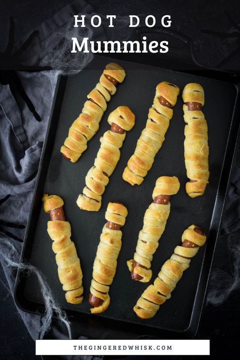 Kids can make these adorable mummy dogs themselves. Made with your favorite hot dogs and crescent rolls, these are a great meal to serve before Trick-or-Treating! Hot Dog Mummies Crescent Rolls, Hot Dog Wrapped In Crescent Roll, Hotdogs In Crescent Rolls, Mummy Hotdogs Crescent Rolls, Crescent Wrapped Hot Dogs, Mummy Hot Dogs Crescent Rolls, Crescent Roll Hot Dogs, Mummy Hot Dogs Recipe, Halloween Mummy Hot Dogs