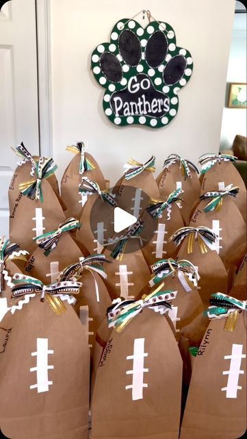 Celebrate with Melissa on Instagram: "I made this cute football shaped bag to give to the girls on our cheer squad! They turned out so cute!! Go Panthers!! 📣🏈💚 #celebratewithmelissa #cheersnacks #treatbag  #footballseason" Football Gift Wrapping Ideas, Gameday Treats For Football Players, Gifts For Football Team, Football Party Gift Bag Ideas, Team Gift Bag Ideas, Cheer Bouquet Ideas, Homecoming Goodie Bag Ideas, Football Snacks For Kids After Game Bags, Spirit Bags Ideas Sports