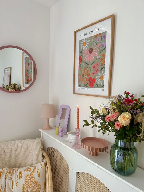 [Ad] Making Use Of Cute Accessories Is The Easiest Way To Upgrade Your Home. IM Obsessed With Colourful Home Interiors With A Vintage Twist, So When Decorating This Small Corner Of My Bedroom, I Focused On Florals, Pastel Colours And Interesting Shapes, Paired With Natural Materials Like Rattan Cane. Items Featured: Rattan Came Sideboard (Diy) Round Pink Mirror (Dunelm) Floral Wall Art (Ellie Mae Designs) Rattan Chair (Ikea) Boucle Throw #colourfullivingroomdecorsmallspaces Colourful Decor Aesthetic, Pastel Cushions Living Rooms, Small Colourful Bedroom Ideas, Colourful Accessories Home, Simple Colourful Bedroom, Floral Vintage Room, Bedroom Decor Pastel, Colourful Home Aesthetic, Pops Of Colour Living Room