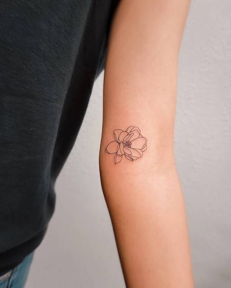 Fine line magnolia flower tattoo located on the inner Magnolia Tattoo Inner Arm, Arm Poppy Tattoo, Magnolia Line Drawing Tattoo, Dainty Magnolia Flower Tattoo, Mini Magnolia Tattoo, Small Gardenia Flower Tattoo, Small Flower Tattoo Inner Arm, One Line Magnolia Tattoo, Flower Tattoos Location