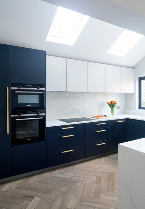 Blue Kitchen With White Cabinets, Flat Panel Kitchen Cabinets, Contemporary Kitchen Furniture, Clean Kitchen Design, Sleek Kitchen Design, Kitchen With White Cabinets, Black Stainless Steel Appliances, Lower Cabinets, Stainless Steel Kitchen Appliances