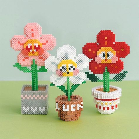 Three flower plants 3D Perler Bead Patterns Tutorial In the tutotial including both three flower patterns in English guidances, step by step teaching you how to make a 3D perler bead. IMPORTANT NOTICE:  This is a digital product, Beads and tools are not included. As this is a digital product, we cannot offer refunds. After payment, digital files will be available to download in your account. To access your digital files from your account: Sign in to Etsy.com and go to Your account. Go to Purchas Perler Bead Designs 3d, Pearler Bead Flower Patterns, Perler Bead 3d Flower, Perler Creations 3d, Perler Bead Home Decor, Perler Bead Flower Bouquet, Peeler Bead Flower, Perler Bead Plants, Perler Plant