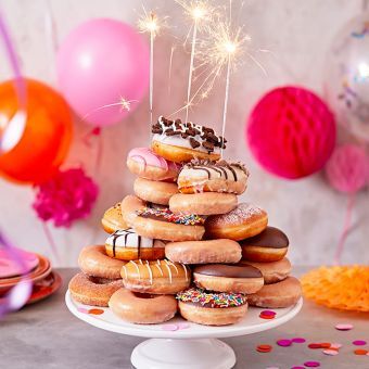 Donuts On Cake Stand, Donut Stacked Cake, Donut Birthday Stack, Donuts Stacked Like A Cake, How To Make A Donut Cake Tower, Tiered Donut Display, Doughnut Stack Cake, Donut Birthday Tower, Stacked Donut Cake Birthday