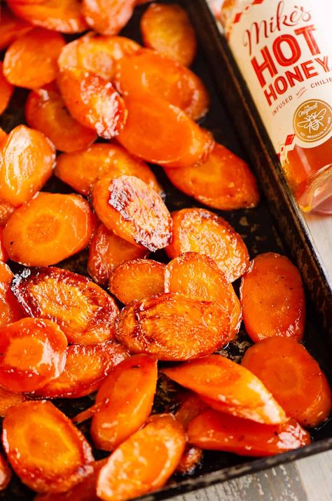 These Hot Honey Roasted Carrots are caramelized to perfection with a hint of spice from the chili infused honey. It's the perfect blend of sweet and spicy for a delicious side dish recipe. Spicy Thanksgiving Recipes, Hot Honey Glazed Carrots, Spiced Honey, Hot Honey Potatoes, Southern Carrots, Roasted Corn Side Dish, Recipes That Use Hot Honey, Honey Carrots Roasted, Hot Honey Roasted Carrots