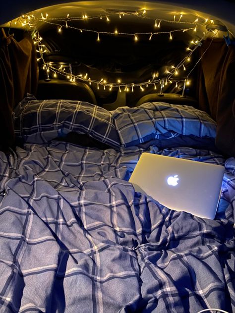 Car set up for car camping. Bed in the car and fairy lights around the edges with curtains to block the light Bed In The Back Of A Car, Sleeping In Tent, Sleeping In Back Of Car, Car Set Up For Road Trip, Bed In Back Of Car, Camping In The Car, Winter Car Camping, Car Fairy Lights, Fairy Lights In Car