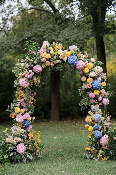 Colorful flower arch in a lush outdoor setting. Unleash your inner florist with wild and whimsical floral wedding ideas that will make your special day bloom like never before. Flower Aisle Runner, Whimsical Floral Wedding, Flower Aisle, Floral Wedding Decor, Floral Wedding Ideas, Outdoor Wedding Decor, Aisle Runner Wedding, Cosmic Love, Floral Wedding Cake