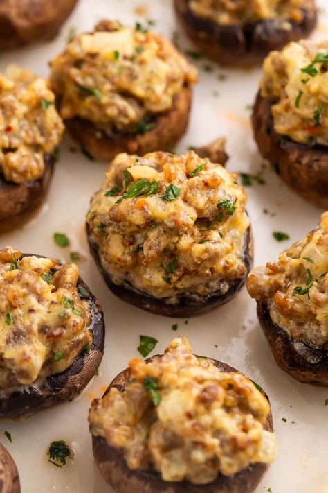 Pass a good time (and some good food) with these party-ready sausage stuffed mushrooms! Greet your guests with a tray of savory, creamy, bite-sized hors d'oeuvres that feel elegant and elevated, but are super easy to make. You might want to be ready with a second tray, though. They disappear fast! Stuffed Mushrooms With Goat Cheese, Easy Stuffed Mushrooms Sausage, Whole 30 Stuffed Mushrooms, Stuffed Sausage Mushrooms, Pesto Stuffed Mushrooms, Cream Cheese Mushrooms Stuffed, Stuffed Mushroom Recipes Sausage, Sausage Cream Cheese Stuffed Mushrooms, Baked Stuffed Mushrooms Oven