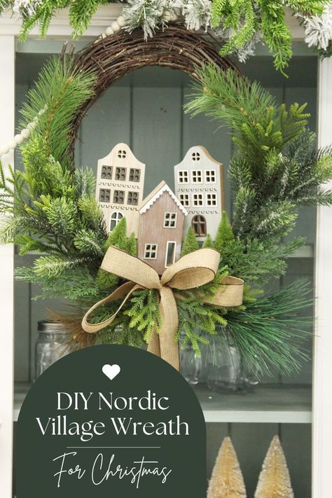 Learn how to craft your own Nordic Christmas village wreath using a twig wreath, greenery, and wooden house village ornaments. Bring the cosy charm of a winter village to your holiday decor with this festive DIY project! Nordic Christmas Crafts, Christmas Village Wreath, Christmas Village Diy, Nordic Village, Village Wreath, Scandi Christmas Decorations, Christmas Styling, Wreath Greenery, House Village