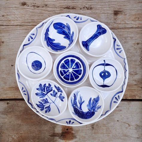 Happy Passover. Each bowl on the Seder Plate is for a different ceremonial food. The orange is a modern symbol added by Jewish feminist scholar, Susannah Heschel, and considered a symbol of inclusion of those who are marginalized within the Jewish community. She said, "The orange suggests the fruitfulness for all Jews when lesbians and gay men are contributing and active members of Jewish life." It is intended that as an orange segment is eaten, the seeds are spit out in a gesture of eliminating Seder Plate Craft, Orange Segment, Passover Plate, Happy Passover, Seder Plate, Play Clay, Ceramic Ideas, Jewish Art, Plate Design