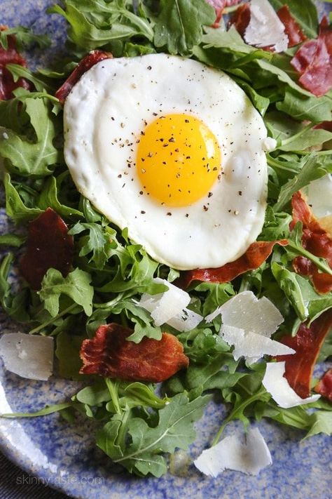 This easy salad has all my favorite things in one – arugula, Proscuitto, shaved Parmesan and a runny egg! When you pop that egg yolk, the salad is bathed in that warm eggy goodness, salad nirvana in every bite! If you are not a fan of runny eggs, hard boiled eggs would taste just fine too! Arugula And Eggs, Arugula Prosciutto, Salad Arugula, Prosciutto Salad, Parmesan Salad, Crispy Prosciutto, Shaved Parmesan, Runny Eggs, Breakfast Salad