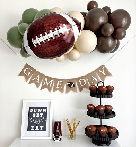 Get your game day celebration ready with our epic party decor!  Complete with sports-themed balloons and a bold 'Game Day' banner, it's the perfect setup to cheer on your favorite team in style.  YOU WILL RECEIVE 1 - Football Balloons, 18 inches An Assortment of Quality Latex Balloons 11 inches and 5 inches 3 ft Balloon Strip Balloon Glue Dots Balloon Garland Instructions Fishing Line One burlap football flags with the words Game Day in white letters. Strings & A Needle for banner assembly Add m First Down Party Decor, Football Tent Decorations, Tailgate Theme Party Decorations, 1 Year Down Football Birthday, 1st Birthday Football Theme Food, Game Day Party Decorations, First Down Party, First Touchdown Birthday, Sports Baby Shower Theme For Boys