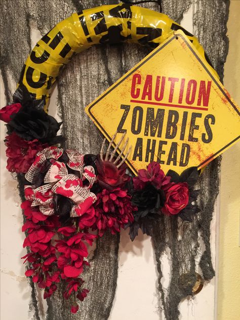 Caution zombies ahead Halloween wreath with caution tape and red floral Zombie Wreath Diy, Zombie Wreath, Diy Zombie Decorations, Scary Halloween Wreath, Zombie Decorations, Zombie Birthday Parties, Wreath Inspiration, Halloween Diy Outdoor, Caution Tape