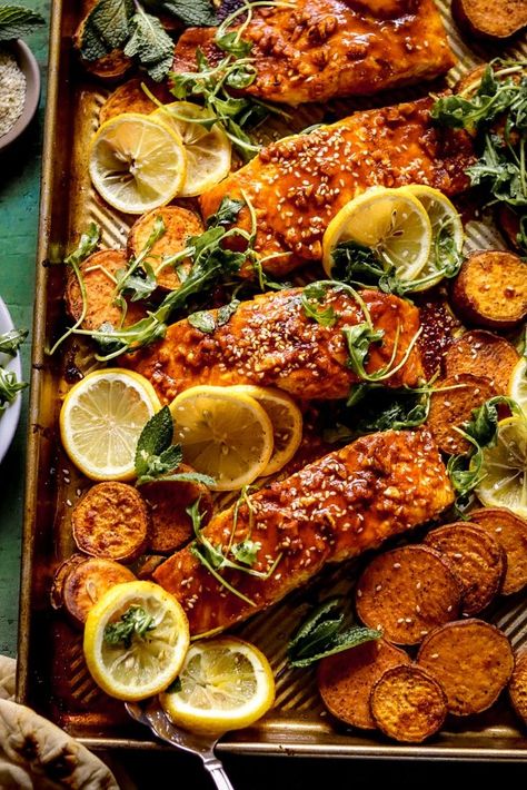 A fun take on a Middle Eastern street food favorite with spiced, lemony baked salmon alongside sweet potatoes. Serve it with naan and sesame arugula for a healthy meal in under an hour. Salmon Stuffed Sweet Potato, Baked Salmon With Potatoes, Salmon Recipes With Sweet Potatoes, Middle Eastern Seafood Recipes, Middle Eastern Salmon Recipes, Sweet Potato And Fish, Middle Eastern Salmon, Salmon And Sweet Potatoes Recipes, Salmon Sweet Potato Recipes