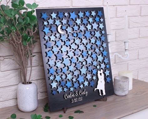 "Celestial wedding guest book alternative Moon and Stars for sign 3D Custom weddung guestbook Bride and Groom Personalized wooden sign This 3d wedding guestbook, a beautiful guest book alternative that is fun for you and your guest. Your guests sign the stars and then you can actually put this wall art into a frame and hang it in your home to enjoy for years to come. You will always remember who shared in your wedding day with you and spouse. We are happy to customize the colors of the guest boo Book Themed Wedding Guest Book, Wedding Guest Painting Ideas, Moon And Stars Themed Wedding, Stars And Moon Wedding Theme, Star And Moon Wedding, Written In The Stars Wedding Theme, Celestial Centerpieces, Unique Wedding Guest Book Alternatives, Moon And Stars Wedding Theme